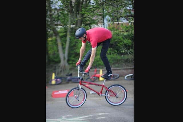 Mike Mullen performs some of his BMX skills.
