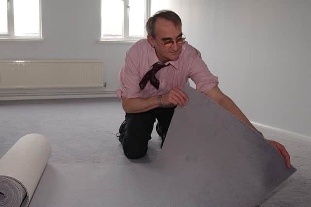 John laying carpet at the home of a resident