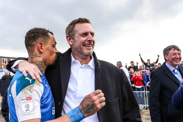 Posh co-owner Darragh MacAnthony with Jonson Clarke-Harris.