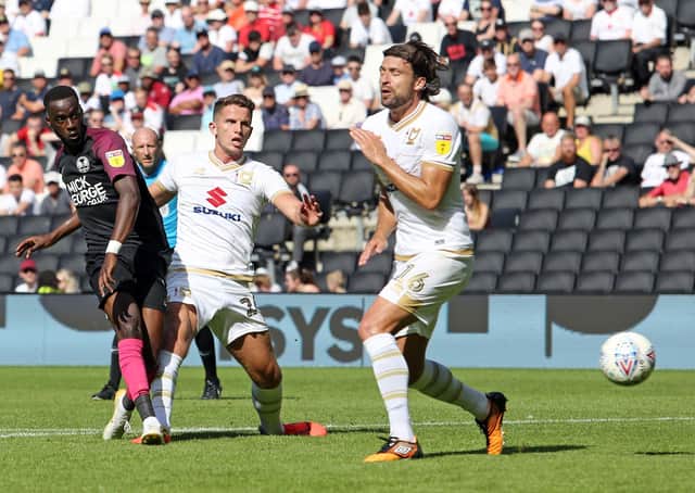 Mo Eisa scores for Posh against MK Dons in August, 2019. Current MK Dons maanager Russell Martin is also pictured. Photo: Joe Dent/theposh.com.