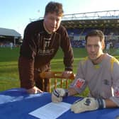 Mark Tyler signs a new Posh contract watched by caretaker-manager Tommy Taylor.