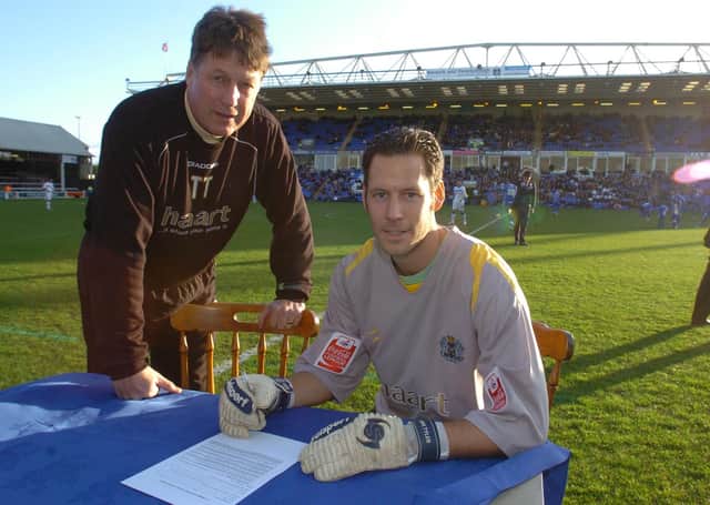 Mark Tyler signs a new Posh contract watched by caretaker-manager Tommy Taylor.