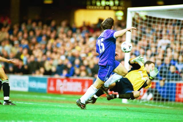 Gianfranco Zola scores for Chelsea past Posh goalkeeper Mark Tyler in a 2001 FA Cup tie at Stamford Bridge.