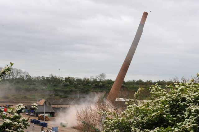 One of the iconic chimneys crashes to the ground. Picture: Chris Lowndes