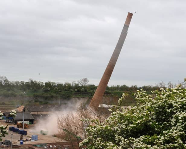 One of the iconic chimneys crashes to the ground. Picture: Chris Lowndes