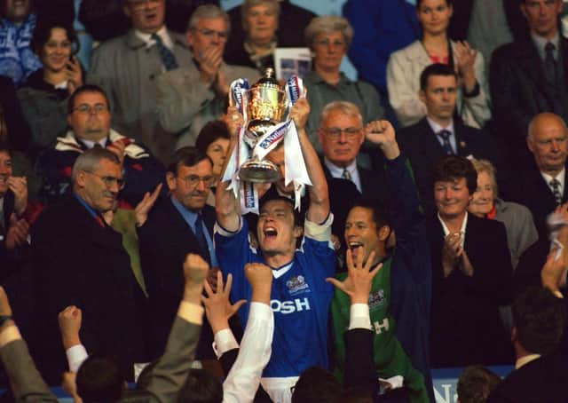 Mark Tyler (right, centre) watches on as Posh skipper Andy Edwards holds aloft the Third Division play-off final trophy at Wembley in May, 2000. Edwards was named in Tyler's all-star team.