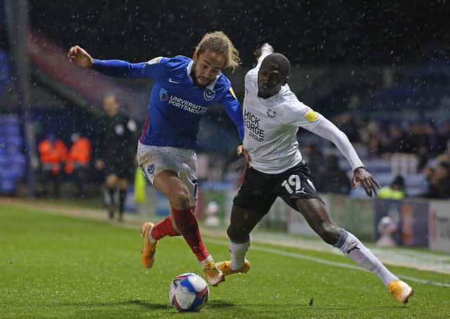 Idris Kanu of Peterborough United battles with Marcus Harness of Portsmouth at Fratton Park last season.
