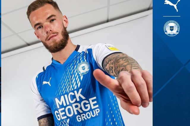 Joe Ward models the Posh home shirt for the 2021-22 season.