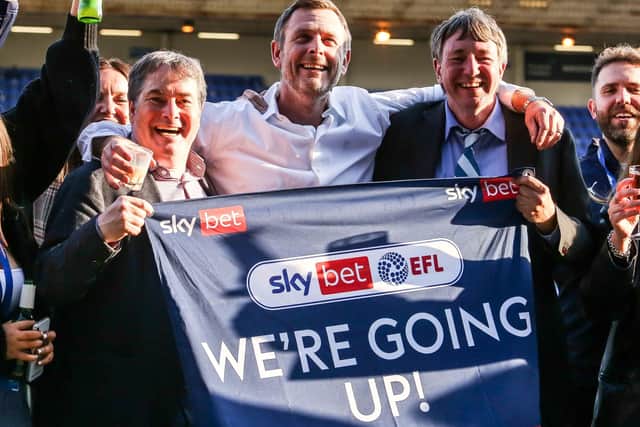 Posh co-owners Stewart Thompson, Darragh MacAnthony and Jason Neale celebrate winning promotion last season.