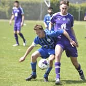 Action from Farcet United's Peterborough Junior Cup quarter-final win over Stanground Sports (purple) last weekend. They will play each other in Peterborough Division Two next season. Photo; David Lowndes.