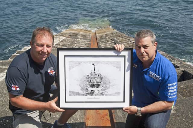 On the old Penlee Lifeboat station slipway near Mousehole, from where the Solomon Browne was lost, Penlee Lifeboat coxswain PatchTM Harvey (left) with fine pencil artist Paul Fulcher depicting the heroic  lifeboat and crew. EMN-210206-145540005