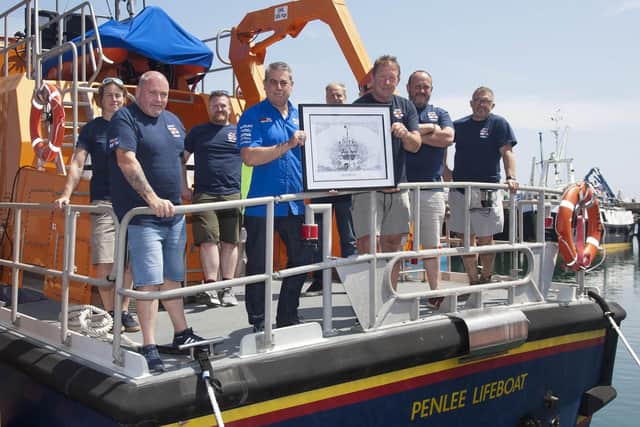 On the old Penlee Lifeboat station slipway near Mousehole, from where the Solomon Browne was lost, Penlee Lifeboat coxswain PatchTM Harvey (left) with fine pencil artist Paul Fulcher depicting the heroic lifeboat and crew. EMN-210206-145540005