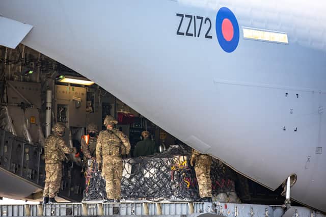 The team from 1AMW loading humanitarian cargo onto a C-17 Globemaster