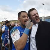 Posh co-owner Darragh MacAnthony (right) with Jonson Clarke-Harris after Posh sealed promotion from League One. Photo: David Lowndes.