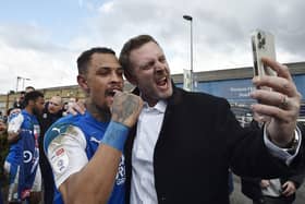 Posh co-owner Darragh MacAnthony (right) with Jonson Clarke-Harris after Posh sealed promotion from League One. Photo: David Lowndes.