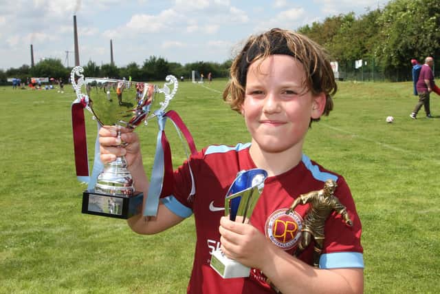 Harry with the cup, his trophy and man on the match award. Credit: RWT Photography