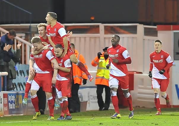 Michael Gash (front) after scoring for Kidderminster at Posh in 2014.
