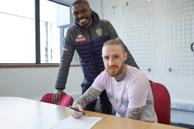 Marcus Maddison signs for Spalding watched by his new manager Gaby Zakuani.