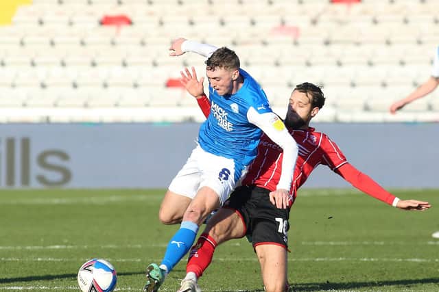 Jack Taylor (left) in action for Posh at Lincoln City last season.