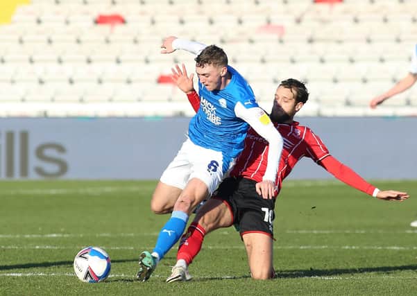 Jack Taylor (left) in action for Posh at Lincoln City last season.
