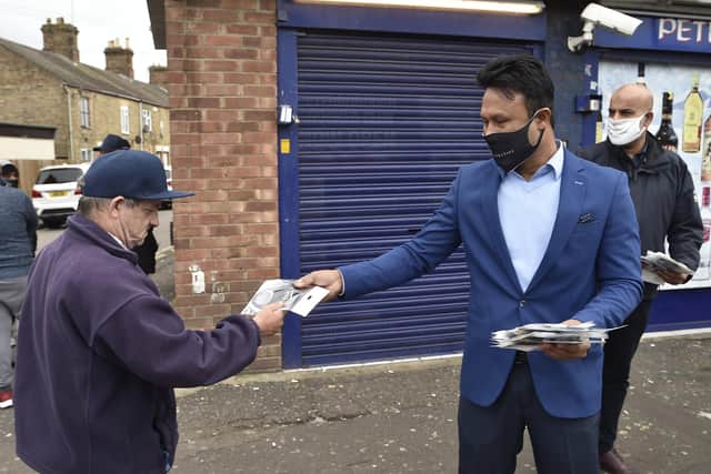 Zillur Hussain handing out free face coverings n Peterborough.