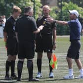 Yaxley Under 18s manager Danny Clifton argues with referee Paul Gale and his assistants. Photo: David Lowndes.