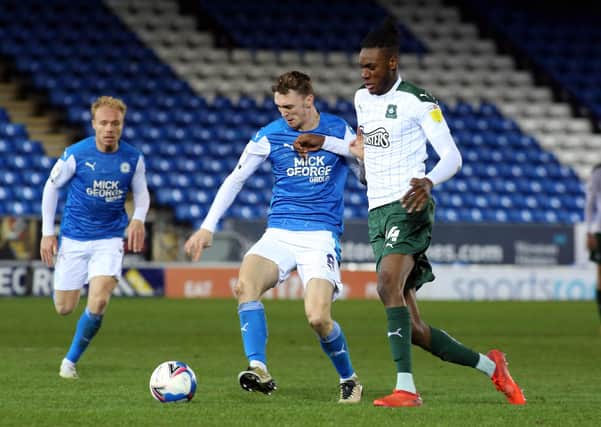 Jack Taylor (left) in action for Posh.