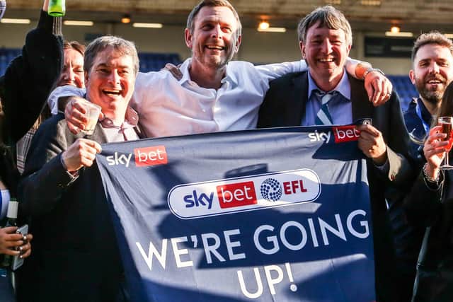 Posh co-owners, from left, Stewart Thompson, Darragh MacAnthony and Dr Jason Neale celebrate promotion to the Championship.