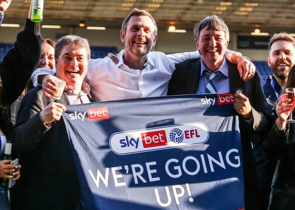 Posh co-owners, from left, Stewart Thompson, Darragh MacAnthony and Dr Jason Neale celebrate promotion to the Championship.