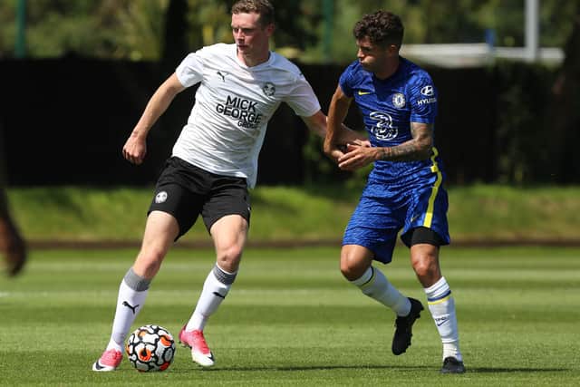 Posh midfielder Ethan Hamilton with Chelsea's Christian Pulisic.  Photo: Joe Dent/theposh.com.