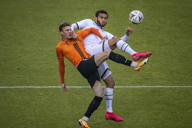 Harry Taylor (left) in action for Barnet against MK Dons. Photo: Justin Setterfield/Getty Images.