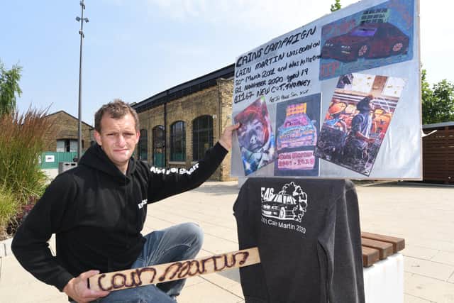 Ernest Martin with his protest material in memory of his son Cain.