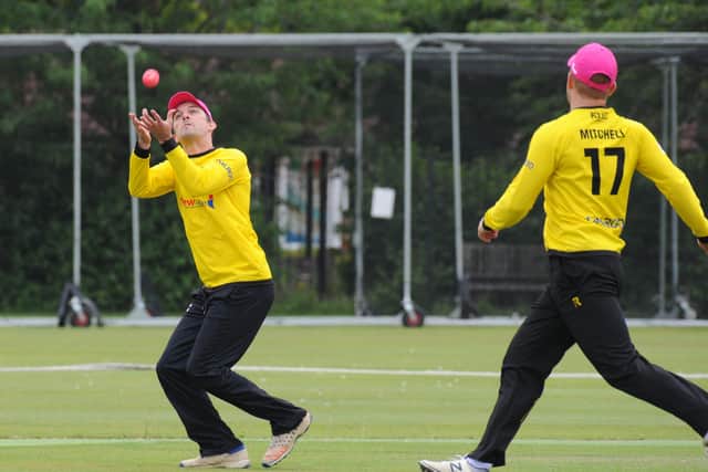 Lewis Bruce takes a catch for Peterborough Town against Geddington. Photo: Chris Lowndes.