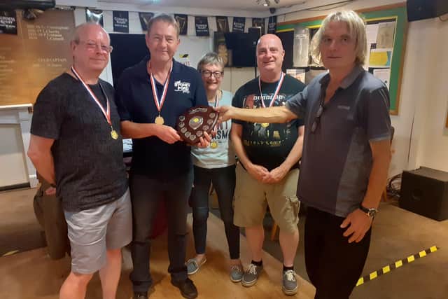 Alan Jones (co-organiser) presenting the trophy to Vine captain Terry Alexander and team David Conway, Bev Yerrell and Mark Walter.