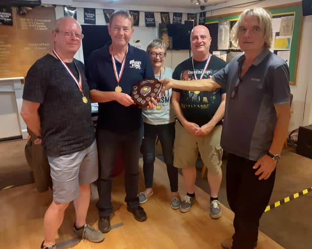 Alan Jones (co-organiser) presenting the trophy to Vine captain Terry Alexander and team David Conway, Bev Yerrell and Mark Walter.