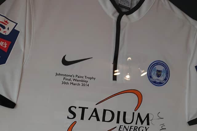 Adrian Durham's signed Posh shirt from the 2014 Johnstone's Paint Trophy Final at Wembley is on display in his office.