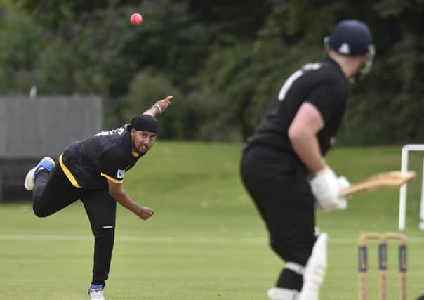 Karanpal Singh on his way to 3-19 from 10 overs for Peterborough Town against Overstone. Photo: David Lowndes.