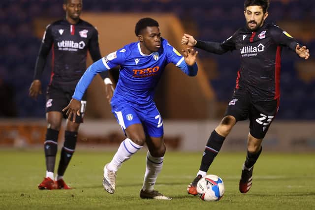 Kwame Poku (blue) in action for Colchester. Photo: James Chance/Getty Images.