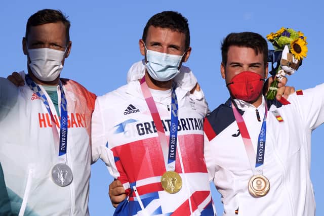Great Britain's Giles Scott (Gold), Hungary's Zsombor Berecz (Silver) and Spain's Joan Cardona Mendez (Bronze) after the Men’s Finn medal race during the Sailing at Enoshima on the eleventh day of the Tokyo 2020 Olympic Games in Japan. PA Wire/PA Images