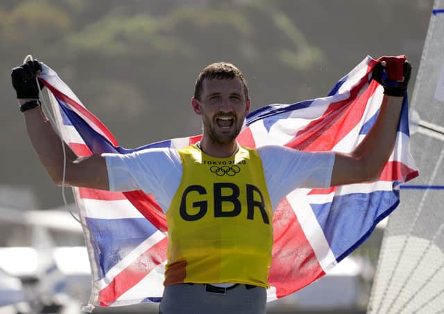 Great Britain's Giles Scott celebrates his Gold after the Men’s Finn medal race during the Sailing at Enoshima on the eleventh day of the Tokyo 2020 Olympic Games in Japan. PA Wire/PA Images