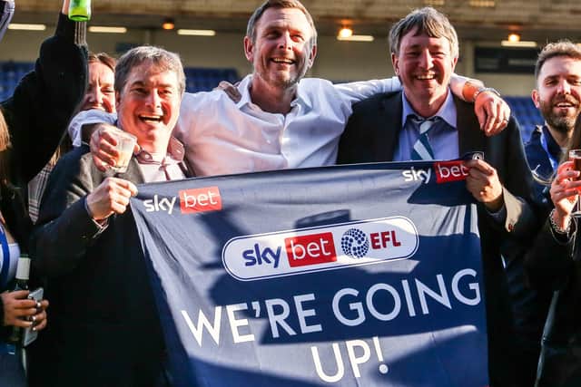 Posh co-owners, from left, Stewart Thompson, Darragh MacAnthony and Dr Jason Neale celebrate winning promotion to the Championship. Photo: Joe Dent/theposh.com.