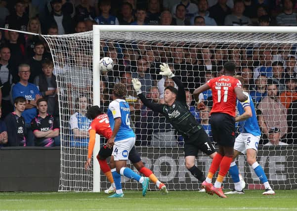 Christy Pym of Peterborough United cant prevent Luton Town from scoring the opening goal of the game. Photo: Joe Dent/theposh.com.
