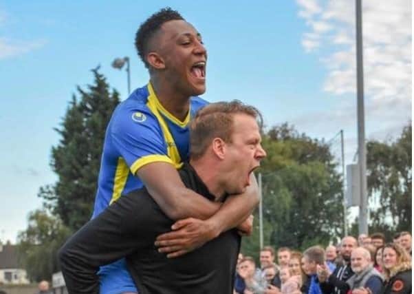 Peterborough Sports manager Jimmy Dean with star forward Dion Sembie-Ferris. They hope to celebrate more success this season. Photo: James Richardson.