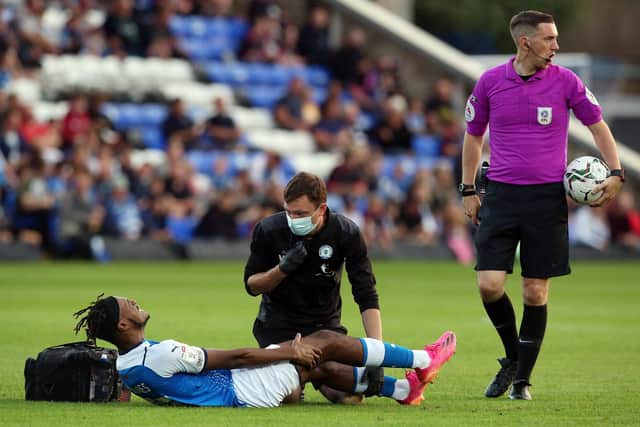 Posh striker Ricky-Jade Jones lies injured on the London Road pitch during the game against Plymouth. Photo: Joe Dent/theposh.com.