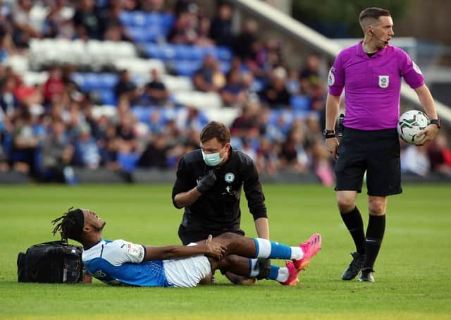 Posh striker Ricky-Jade Jones lies injured on the London Road pitch during the game against Plymouth. Photo: Joe Dent/theposh.com.