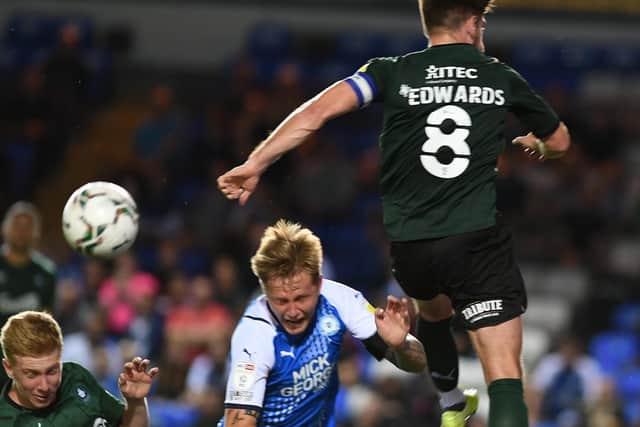 Posh defender Frankie Kent is on his way down in the game against Plymouth. Photo: David Lowndes.