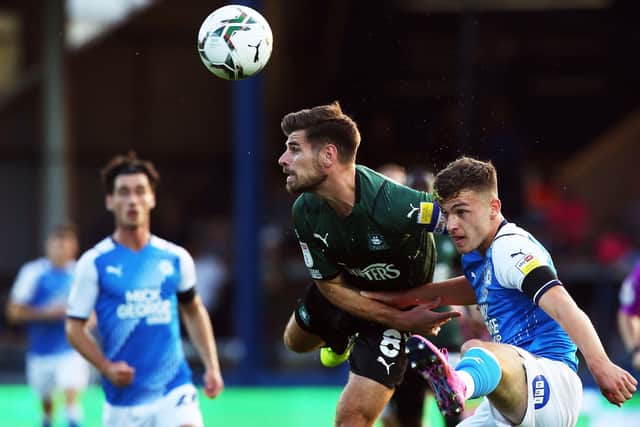 Harrison Burrows of Peterborough United in action with Joe Edwards of Plymouth Argyle. Photo: Joe Dent/theposh.com.