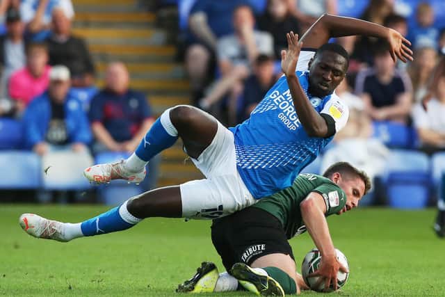 Idris Kanu of Peterborough United is fouled by Jordan Houghton of Plymouth Argyle. Photo: Joe Dent/theposh.com.