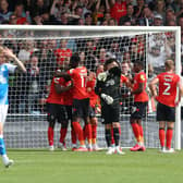 Posh players are dejected as Luton celebrate a goal at Kenilworth Road last weekend.