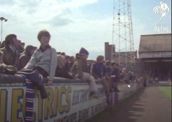 Watching the game at London Road in the 70s in a scene from Pathe News footage.